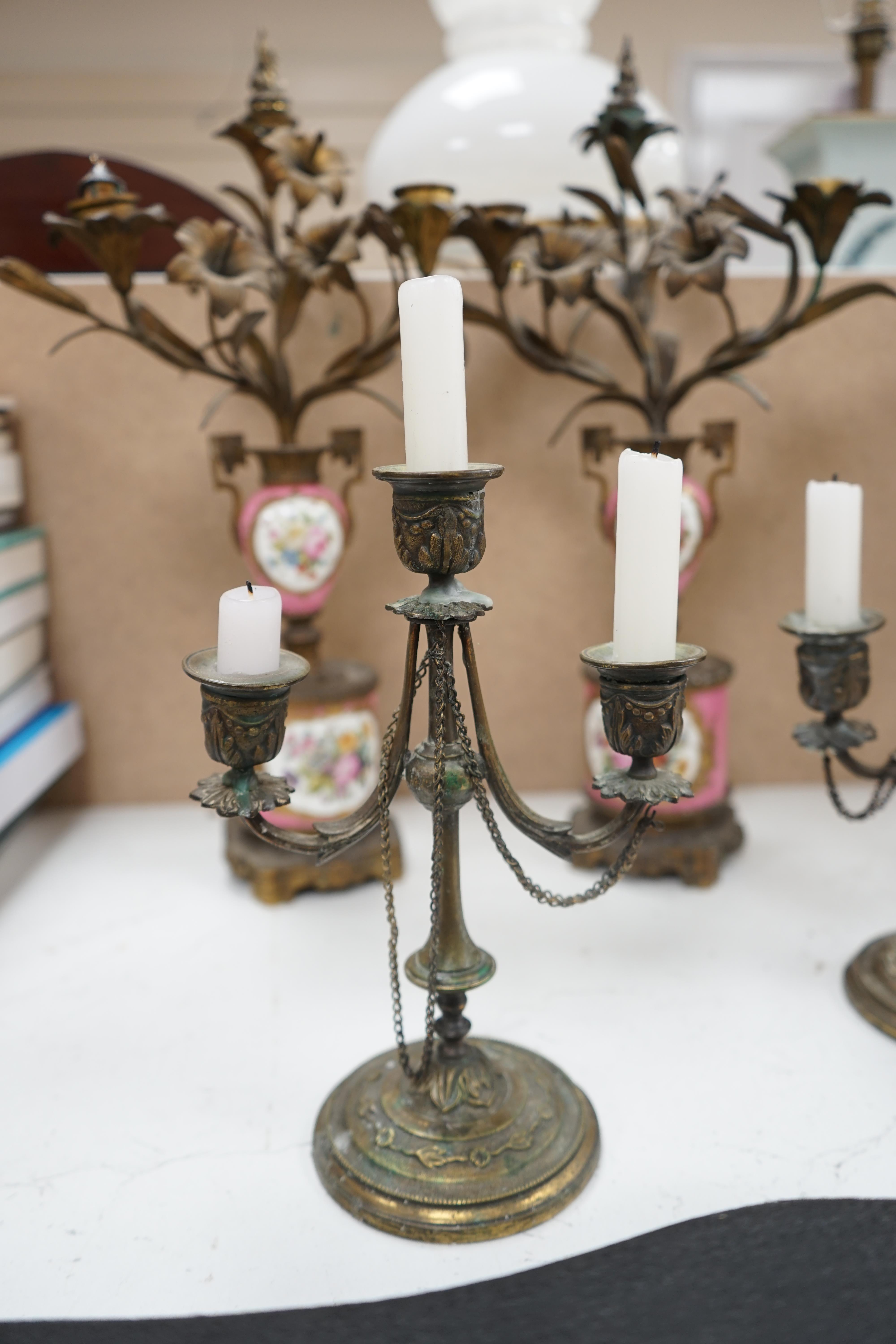 A pair of French porcelain mounted gilt metal candelabra and one other pair, tallest 45cm. Condition - fair